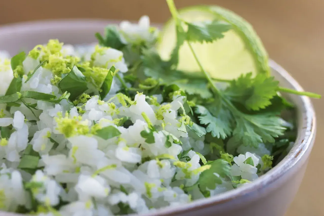 En skål med fluffigt mexikanskt ris, toppat med färsk koriander och limezest. Perfekt som tillbehör till din favorit tacorätt.