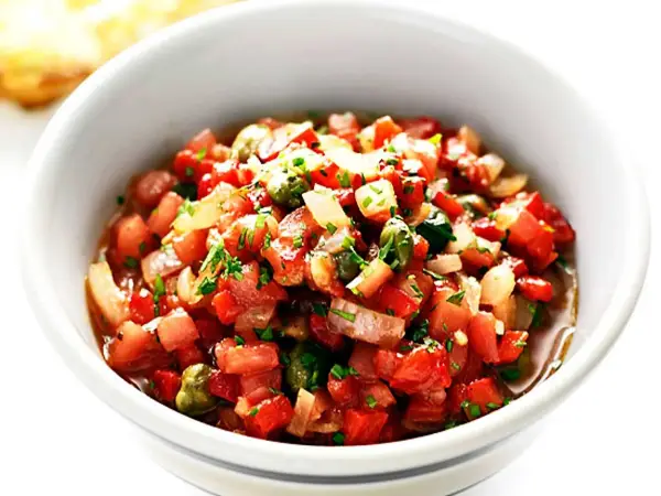 En skål med färsk salsa, perfekt för ditt salsa recept. Tomater, lök och örter blandas till en läcker röra.